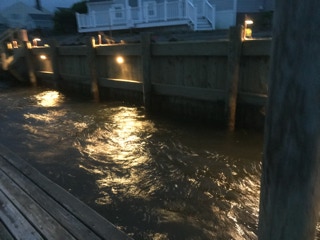 Dock, lit at night by Dependable Landscaping