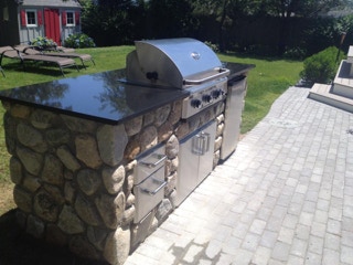 New stone patio and BBQ, installed by Dependable Landscaping